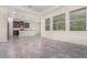 Open-concept living area showcases tile floors, lots of windows, and seamless flow into the gourmet kitchen at 5871 Alenlon Way, Mount Dora, FL 32757