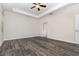 Bright and airy main bedroom with tray ceiling, fan, and wood-look flooring at 5871 Alenlon Way, Mount Dora, FL 32757