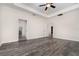 Spacious main bedroom features tray ceiling, fan, wood-look flooring, and ensuite bathroom access at 5871 Alenlon Way, Mount Dora, FL 32757