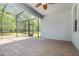 Screened patio with brick flooring and a ceiling fan, offering a relaxing outdoor space at 5871 Alenlon Way, Mount Dora, FL 32757