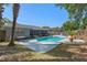 Spacious backyard with a pool, screened-in patio, and a cozy fire pit area at 611 Green Briar Blvd, Altamonte Springs, FL 32714