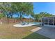 Wide shot of the backyard, featuring a pool, patio, fire pit, and screened lanai at 611 Green Briar Blvd, Altamonte Springs, FL 32714