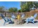 Backyard stone fire pit surrounded by blue Adirondack chairs with patterned cushions at 611 Green Briar Blvd, Altamonte Springs, FL 32714
