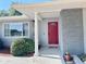 Inviting front entrance featuring a red door with decorative glass and manicured landscaping at 611 Green Briar Blvd, Altamonte Springs, FL 32714