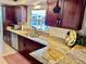 Beautiful updated kitchen with granite countertops, stainless dishwasher and sink, and dark wood cabinets at 611 Green Briar Blvd, Altamonte Springs, FL 32714