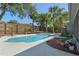 Outdoor pool area featuring lush landscaping, a wooden fence, and palm trees at 611 Green Briar Blvd, Altamonte Springs, FL 32714