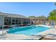 Backyard pool with an adjacent screened-in lanai and a fire pit area at 611 Green Briar Blvd, Altamonte Springs, FL 32714
