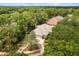 Aerial view of a home featuring a tile roof, well-kept landscaping, and a two-car garage at 612 Stonefield Loop, Lake Mary, FL 32746