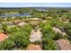 Aerial view of a community with mature trees, lake, and beautiful homes at 612 Stonefield Loop, Lake Mary, FL 32746