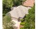 Aerial view of a home featuring a tile roof, well-kept landscaping, and a two-car garage at 612 Stonefield Loop, Lake Mary, FL 32746