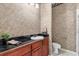 Cozy bathroom with patterned wallpaper, black counters, and a modern sink at 612 Stonefield Loop, Lake Mary, FL 32746