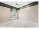 A bright bedroom with a large arched window and neutral carpet at 612 Stonefield Loop, Lake Mary, FL 32746