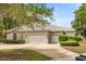 Spacious three-car garage with neutral paint and well-maintained landscaping adding curb appeal at 612 Stonefield Loop, Lake Mary, FL 32746