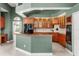 Spacious kitchen featuring wood cabinetry, an eat-in bar, and modern appliances at 612 Stonefield Loop, Lake Mary, FL 32746