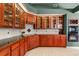 A kitchen featuring wood cabinets with glass doors and modern appliances at 612 Stonefield Loop, Lake Mary, FL 32746