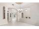 Bright living room with arched entryway, stylish lighting, and tile flooring at 612 Stonefield Loop, Lake Mary, FL 32746