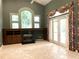Open living room with tile floors, built-in fireplace, and French doors to the outdoors at 612 Stonefield Loop, Lake Mary, FL 32746