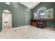 Open living room with tile floors and built-in fireplace, under a high vaulted ceiling at 612 Stonefield Loop, Lake Mary, FL 32746
