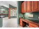 Built-in desk area with drawers and overhead cabinet, adjacent to an open-concept living area at 612 Stonefield Loop, Lake Mary, FL 32746