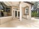 Covered patio with outdoor kitchen and bar area featuring white cabinetry with mini fridge at 612 Stonefield Loop, Lake Mary, FL 32746