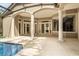 Large covered patio with columns, and multiple french doors leading into the house with pool access at 612 Stonefield Loop, Lake Mary, FL 32746