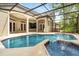 A beautiful pool with a rock fountain and screened-in lanai providing a peaceful oasis at 612 Stonefield Loop, Lake Mary, FL 32746
