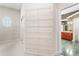Spacious walk-in closet with wire shelving and a view of the ensuite bathroom at 612 Stonefield Loop, Lake Mary, FL 32746