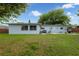 Spacious backyard with patio, lawn, and perimeter privacy fence at 6431 Greylynne St, Orlando, FL 32807