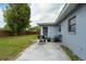 Backyard patio with outdoor seating area and landscaped yard at 6431 Greylynne St, Orlando, FL 32807