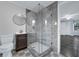 Bathroom featuring a glass shower with decorative tile flooring and modern fixtures at 6431 Greylynne St, Orlando, FL 32807