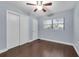 Bedroom with closet, window, ceiling fan and hardwood floors at 6431 Greylynne St, Orlando, FL 32807