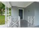 A cozy front porch showcasing decorative wrought iron railings and a classic, welcoming front door at 6431 Greylynne St, Orlando, FL 32807