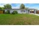 Neat single-story house with a well-manicured lawn, a carport, and freshly painted exterior at 6431 Greylynne St, Orlando, FL 32807