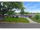 Quaint single-story home featuring a lush green lawn, mature trees and a convenient carport at 6431 Greylynne St, Orlando, FL 32807
