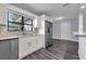 Bright kitchen featuring granite counters, stainless appliances, white cabinetry and modern fixtures at 6431 Greylynne St, Orlando, FL 32807
