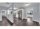 Modern kitchen area with stainless steel appliances, white cabinets, granite countertops, and a breakfast bar at 6431 Greylynne St, Orlando, FL 32807