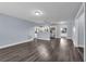 Open-concept living space with modern gray flooring, fresh paint, and seamless flow to the kitchen at 6431 Greylynne St, Orlando, FL 32807