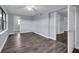 Spacious living room with new gray toned wood flooring and neutral paint at 6431 Greylynne St, Orlando, FL 32807