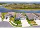 Aerial view of a property showcasing its proximity to a tranquil lake and surrounding residential area at 6960 Audobon Osprey Cv, Harmony, FL 34773