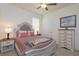 Bright bedroom featuring neutral walls, ceiling fan, plush carpet and decorative bedding and furnishings at 6960 Audobon Osprey Cv, Harmony, FL 34773