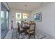Bright dining room features a decorative chandelier and large windows overlooking water at 6960 Audobon Osprey Cv, Harmony, FL 34773