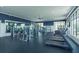 Well-equipped fitness center with treadmills, weight machines, mirrors, and large windows for natural light at 6960 Audobon Osprey Cv, Harmony, FL 34773