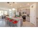 Open-concept kitchen with gray cabinets, granite countertops, a large island, and stainless steel appliances at 6960 Audobon Osprey Cv, Harmony, FL 34773