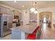 Stylish kitchen with gray cabinetry, granite counters, and a spacious island with bar stool seating at 6960 Audobon Osprey Cv, Harmony, FL 34773