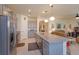 Spacious kitchen with an island bar flowing into the living area, perfect for entertaining guests at 6960 Audobon Osprey Cv, Harmony, FL 34773