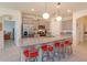 Modern kitchen boasts gray cabinets, granite countertops, a large island, and stainless steel appliances at 6960 Audobon Osprey Cv, Harmony, FL 34773