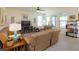 Spacious living room with bright windows, a ceiling fan, and comfortable seating at 6960 Audobon Osprey Cv, Harmony, FL 34773