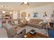 Open-concept living room with comfortable seating, leading into a kitchen area at 6960 Audobon Osprey Cv, Harmony, FL 34773