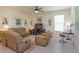 Inviting living room features neutral decor, tile floors, plush seating, and a ceiling fan at 6960 Audobon Osprey Cv, Harmony, FL 34773