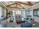 Spacious lounge area with exposed wood beams, comfortable seating, and a modern fireplace feature at 6960 Audobon Osprey Cv, Harmony, FL 34773